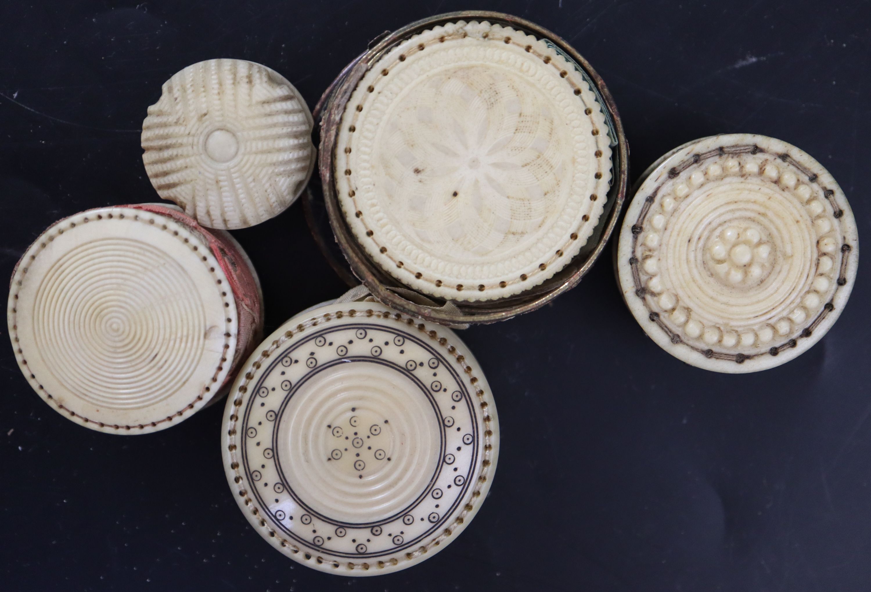 A collection of twelve 19th century carved ivory and bone pin cushions